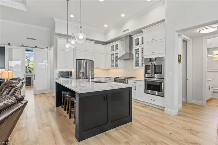 View of the kitchen into the den with double sliding doors!