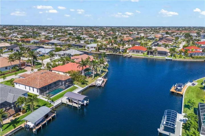 Proudly offering an incredible view and layout - we truly live in paradise and this home has breathtaking views of the intersecting canal - over 10 feet and everything you need is done for you - a canopied boat area, composite dock, additional 10x13 sitting pier, paved full length additional waterfront patio along the seawall - a dream location and home!