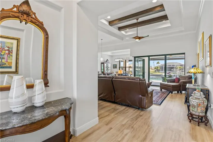 Foyer entry with double tiered tray ceiling, wood beam accents and 90 degree disappearing sliders!