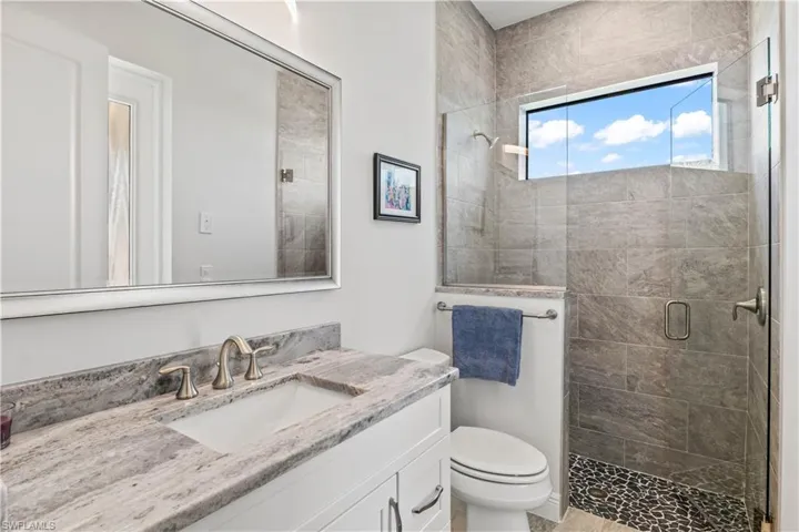 Guest hallway bathroom with large walk in shower.