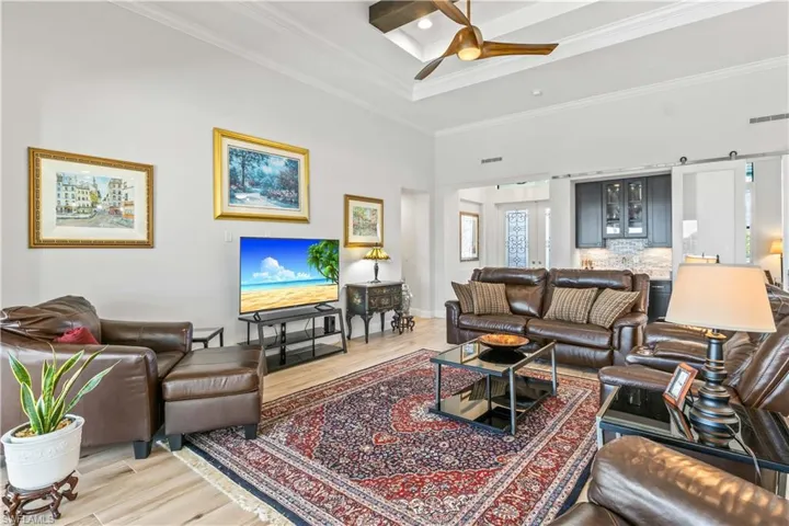 Great room that easily accommodates larger furniture setups with plenty of room to move around.  Full wetbar with sink, beverage fridge and a sliding barn door to hide if desired!