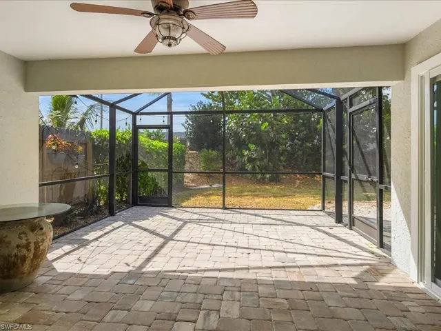Unfurnished sunroom featuring ceiling fan