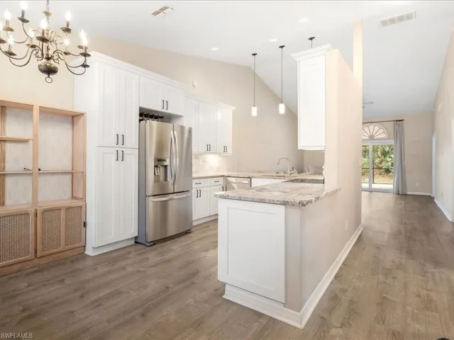 Beautiful Kitchen featuring a sink, appliances with stainless steel finishes, a peninsula,