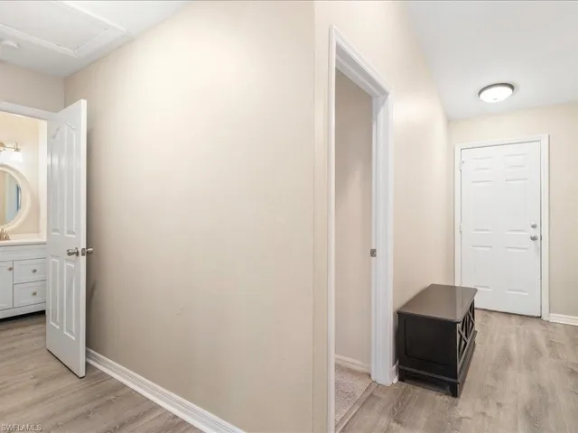Hallway featuring baseboards and light wood-type flooring