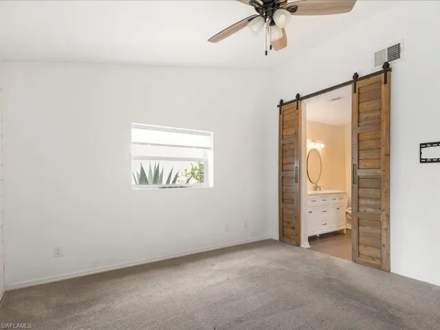 Master ensuite, with a barn door leading to spacious bath