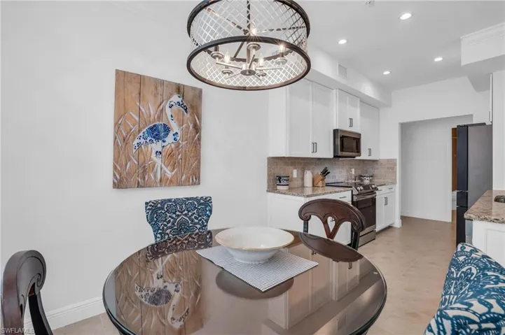 Tiled dining room with an inviting chandelier