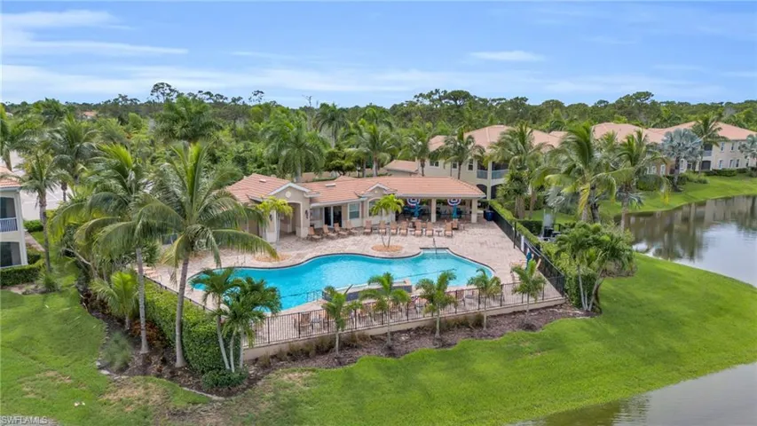 View of pool with a patio and a lawn