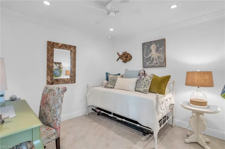 Tiled Den/Office featuring crown molding and ceiling fan.