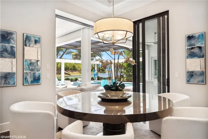 Dining area featuring a notable chandelier and crown molding