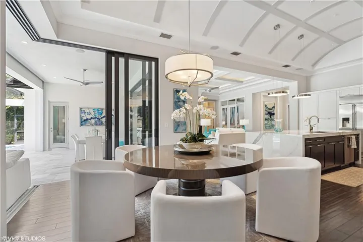 Dining room featuring sink, coffered ceiling, hardwood / wood-style flooring, and ceiling fan