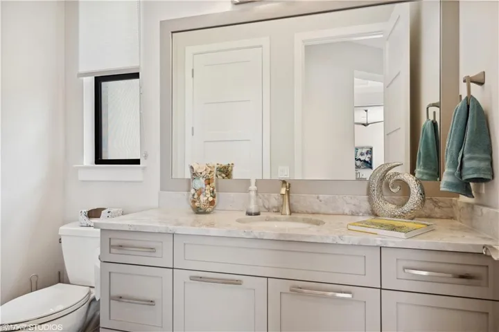 Bathroom featuring oversized vanity and toilet