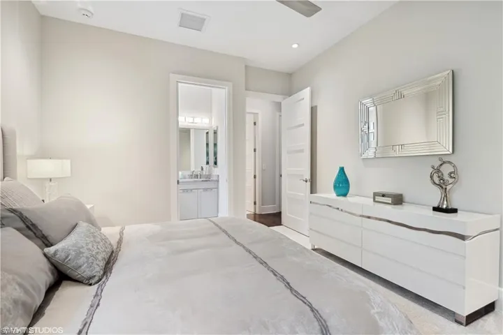 Bedroom with light colored carpet and ensuite bath