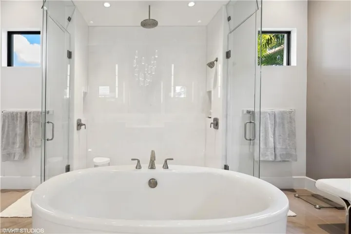Bathroom featuring shower with separate bathtub