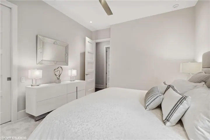 Bedroom featuring light carpet and ceiling fan