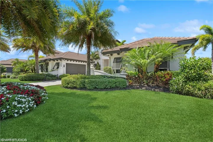 Mediterranean / spanish home with a garage and a front yard