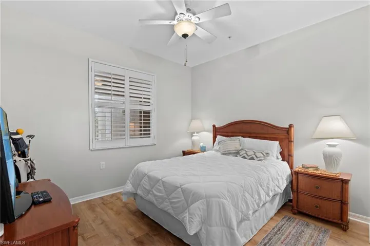 Bedroom with ceiling fan and light hardwood / wood-style floors