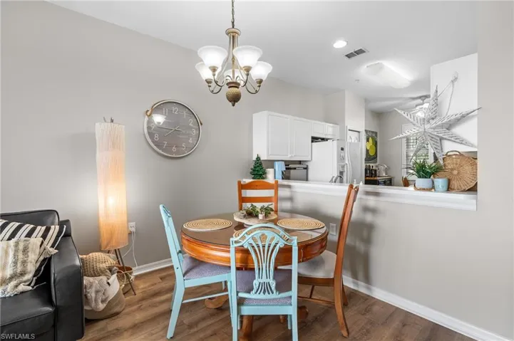 Dining space featuring hardwood / wood-style flooring and an inviting chandelier
