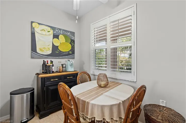 Tiled dining room featuring ceiling fan