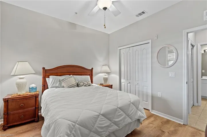 Bedroom featuring ceiling fan, a closet, and light hardwood / wood-style flooring