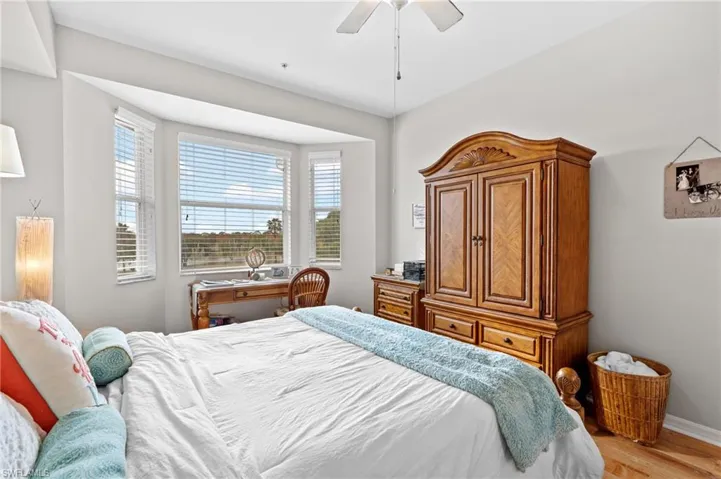 Bedroom with ceiling fan and light hardwood / wood-style flooring