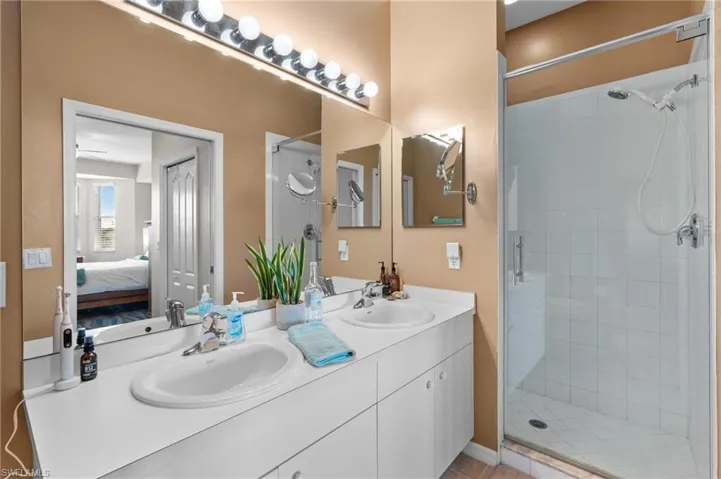 Bathroom featuring vanity and a shower with shower door