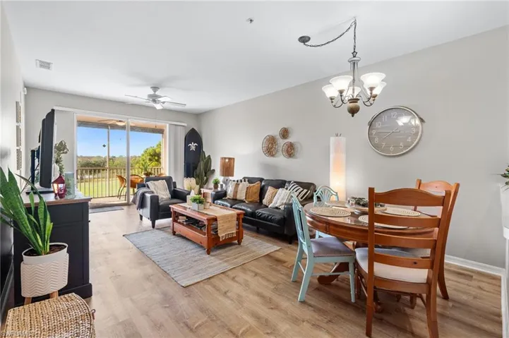 Dining room featuring ceiling fan with notable chandelier and light hardwood / wood-style floors