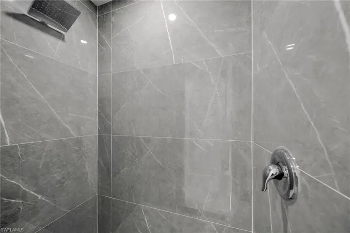 Room details featuring tiled shower