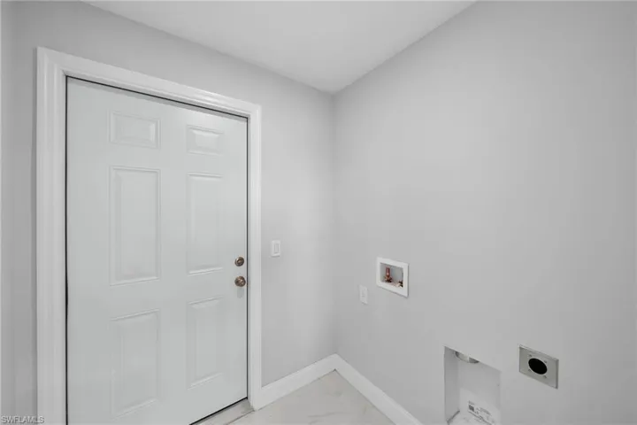 Laundry area with tile floors, hookup for a washing machine, and electric dryer hookup