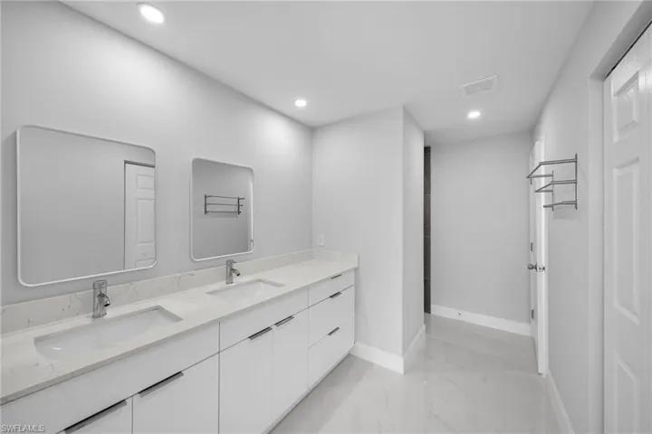 Bathroom with double vanity and tile floors