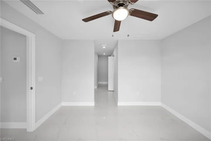 Tiled empty room with ceiling fan