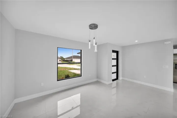 Unfurnished room featuring light tile floors