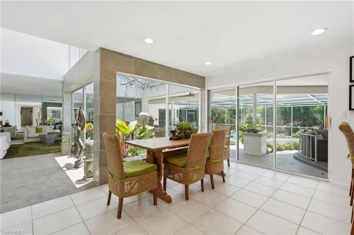 Dining area featuring square tile flooring and recessed lighting