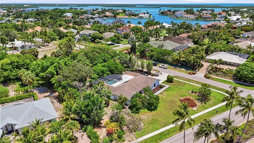 Aerial perspective showcasing a residential property with a light-colored roof