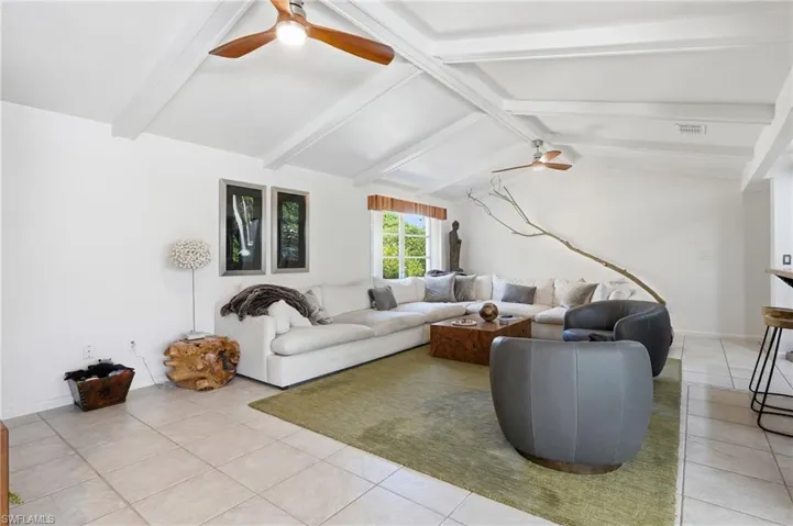Vaulted ceiling with exposed white beams and ceiling fans