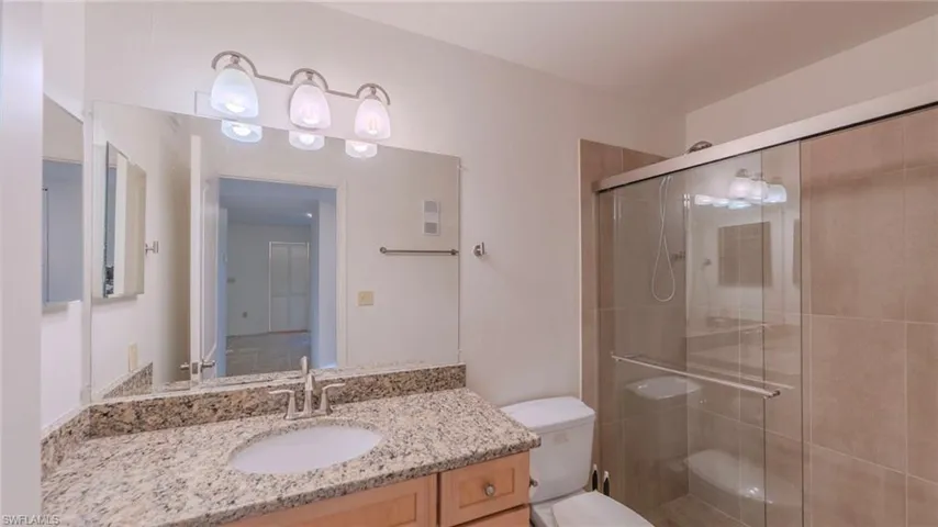 Full bath with vanity and a shower stall