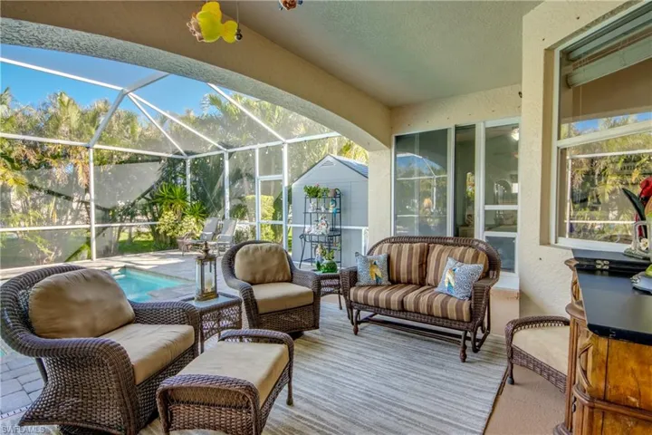 View of patio with an outdoor living space and glass enclosure