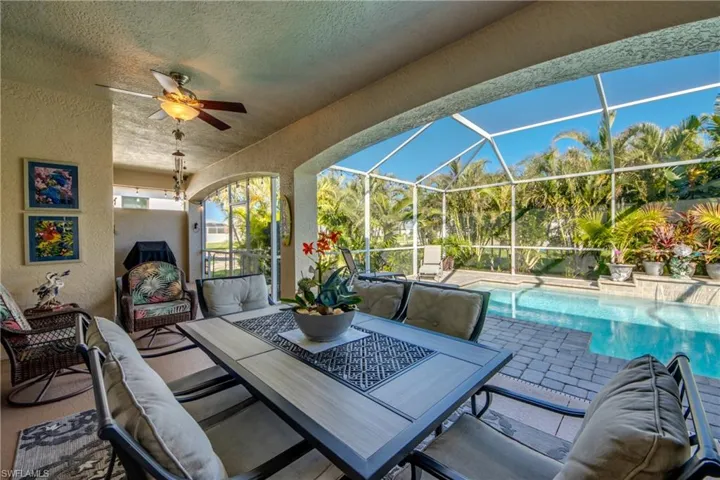 View of patio with a lanai, ceiling fan, and an outdoor living space