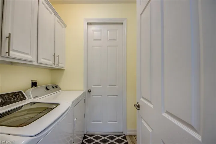 Laundry room with washer and dryer and cabinets