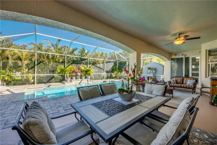 View of patio featuring outdoor lounge area, glass enclosure, and ceiling fan