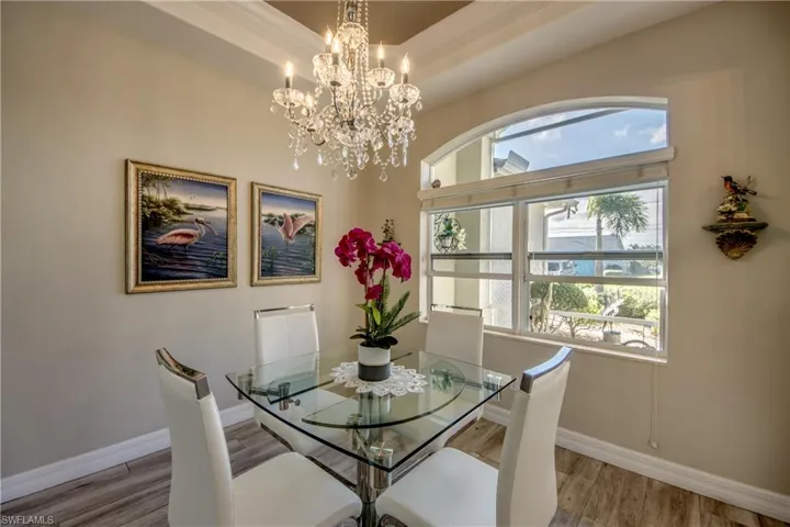 Dining area with a chandelier and wood-type flooring