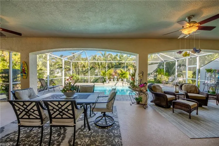 Sunroom / solarium with ceiling fan and a healthy amount of sunlight