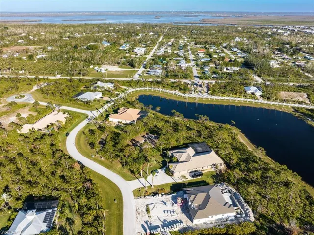 Aerial overview of property's location with a large body of water and nearby suburban area