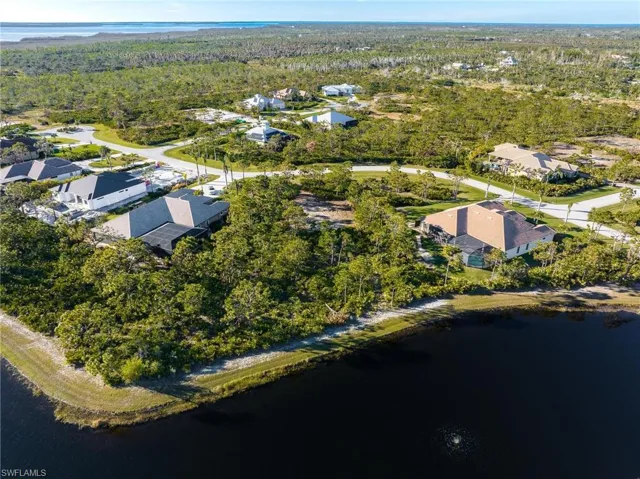Aerial overview of property's location with a large body of water and nearby suburban area