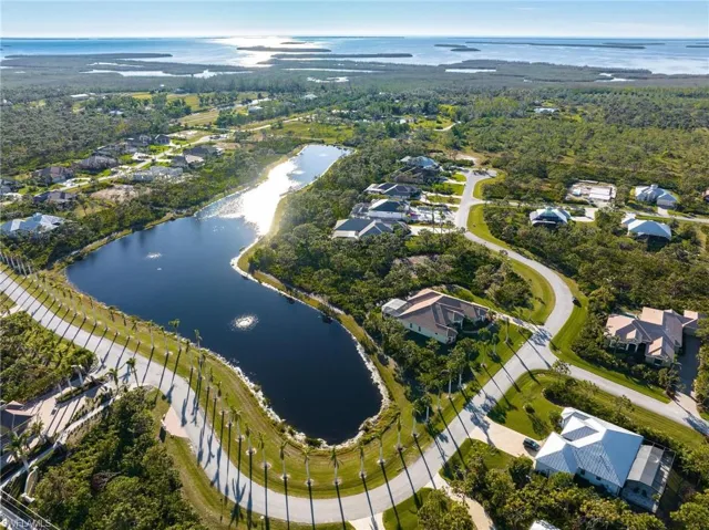 Aerial view of property's location with a nearby body of water and nearby suburban area