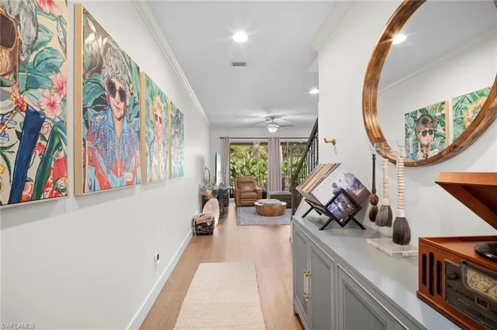 Corridor featuring crown molding, light wood-style flooring, and recessed lighting