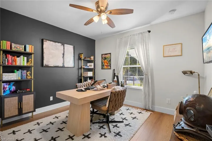 Office space featuring light wood-style floors and a ceiling fan