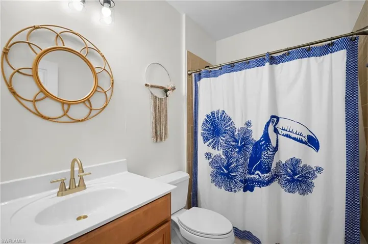 Bathroom featuring vanity and curtained shower
