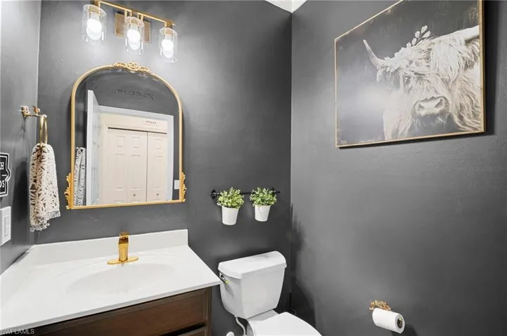 Half bath with vanity and toilet