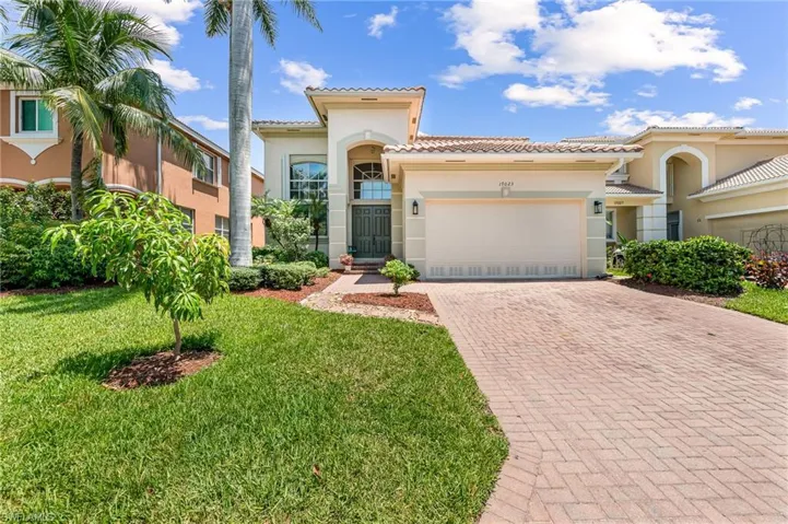 Mediterranean / spanish-style home featuring a garage and a front yard