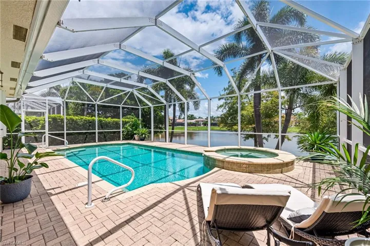 View of swimming pool , a water view, an in ground hot tub, and a patio area